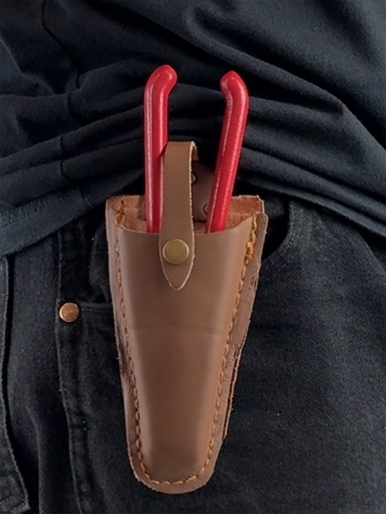 Close-up of the durable leather surface and fine stitching of the pruner sheath. The sheath offers rust protection, ensuring your gardening tools stay secure and ready for use.